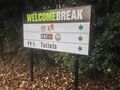 A sign saying Welcome Break, with arrows pointing towards KFC, Coffee Primo, Burger King and EAT IN.